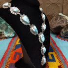 Golden Hills turquoise necklace by Randall Endito with linked scalloped silver settings and three descending center stones.