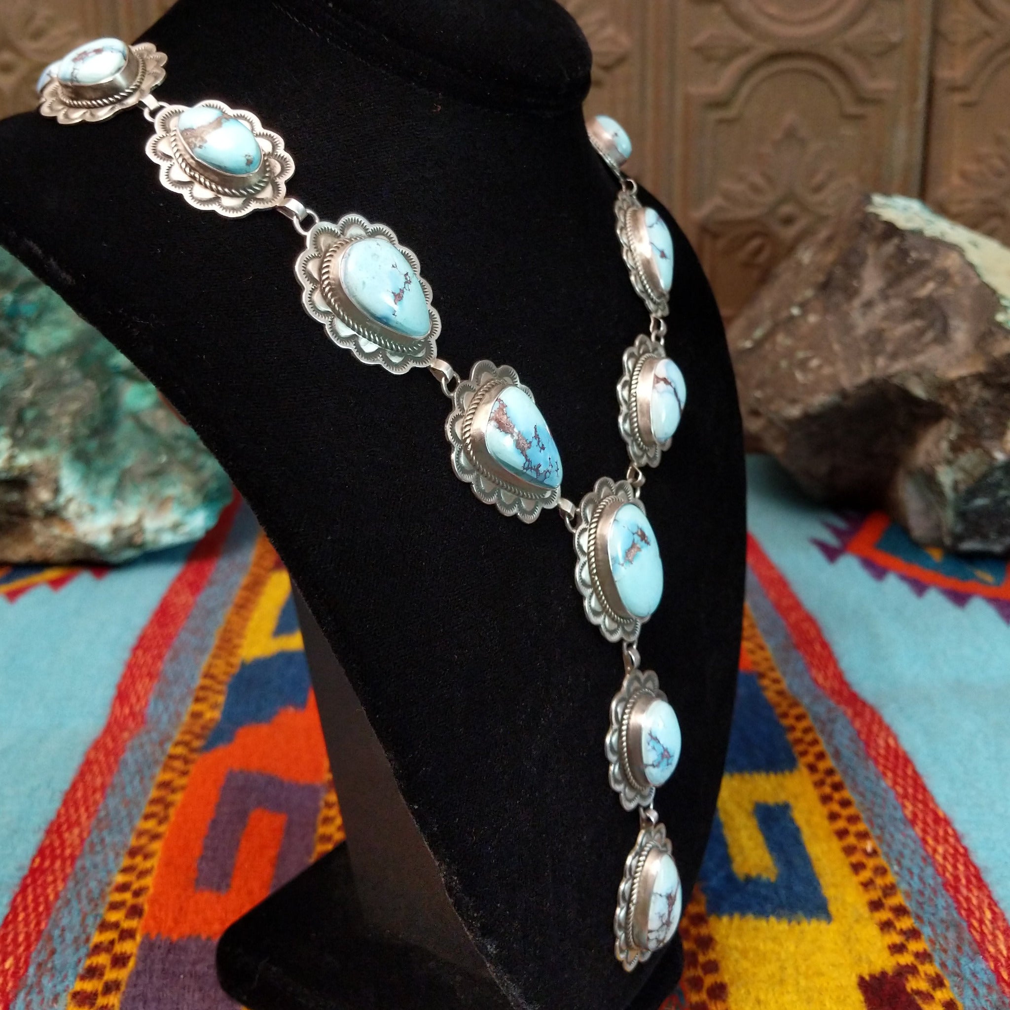 Golden Hills turquoise necklace by Randall Endito with linked scalloped silver settings and three descending center stones.