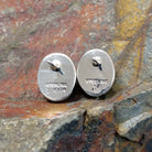 The stamped/signature view of the golden hills turquoise oval earrings features a small hallmark near the post, marking Diane Wylie’s artistry.