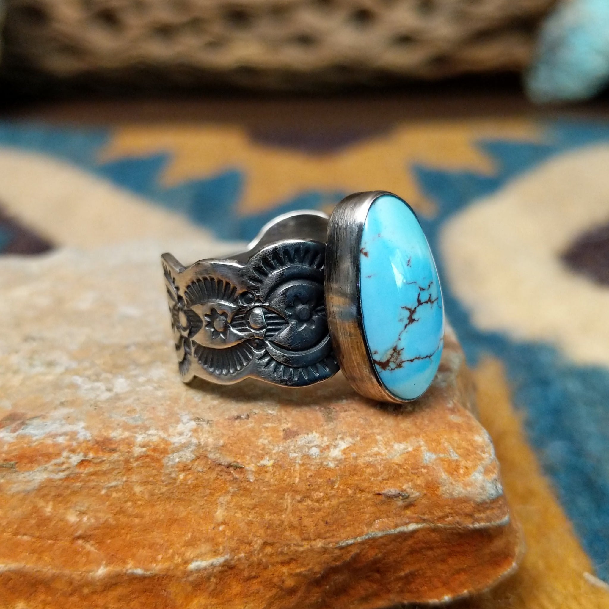 Handcrafted sterling silver Golden Hills turquoise ovoid ring by Leonard Maloney, featuring a natural sky-blue Golden Hills turquoise gemstone with lavender-gray matrix; side view.