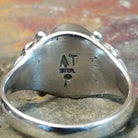 Silver ring with clear signature on the inner band, no stones or decoration present.