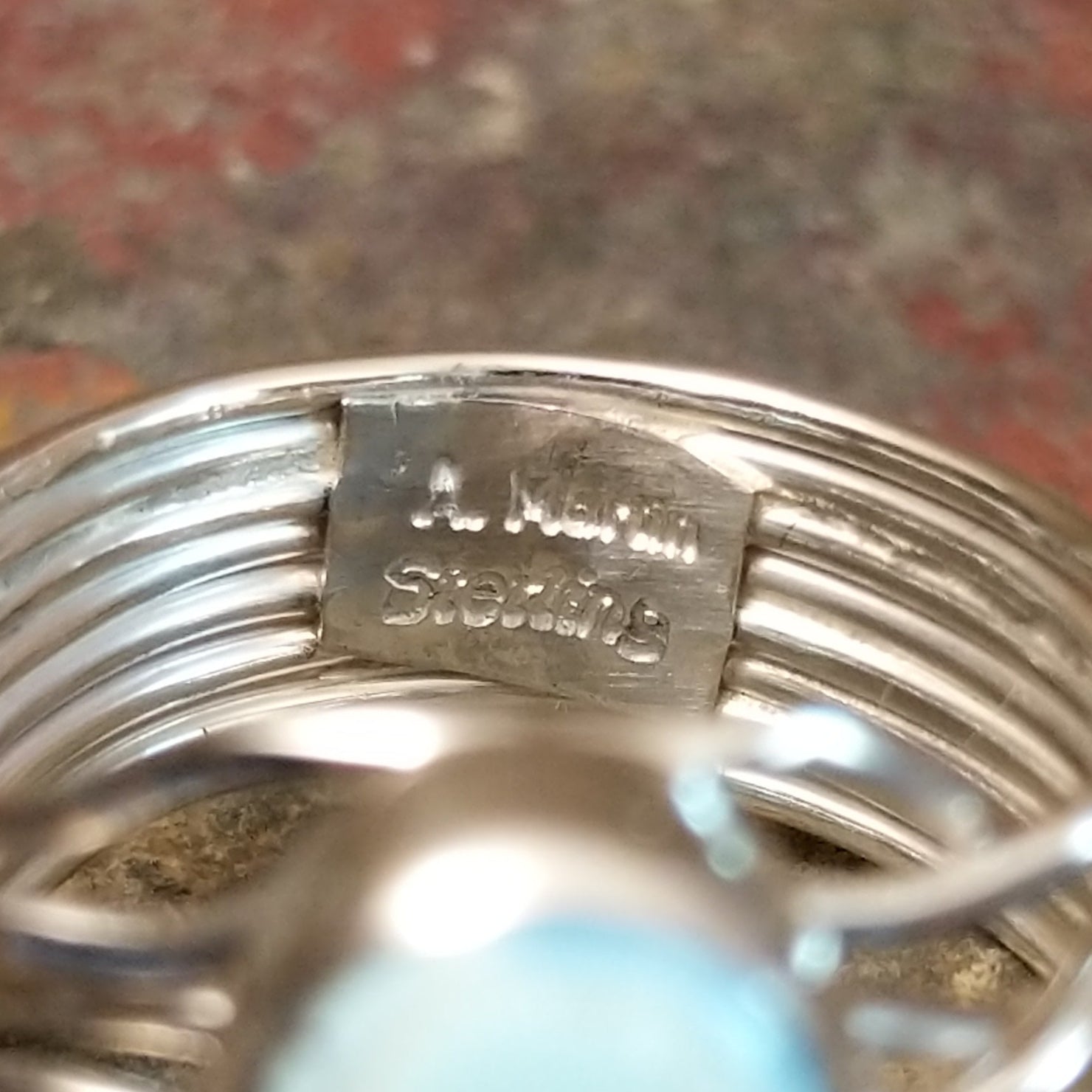 Silver ring with signature on the inner band, no stones or decoration present.