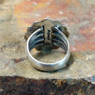 Silver ring with a plain band, no stone visible. Smooth silver finish with scalloped design.