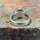 Silver ring with a plain band, no stone visible, finished in a polished silver sheen.