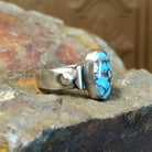 The ring’s band features polished silver with subtle silver ball accents.