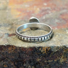 Silver ring with a plain twisted, ribbed band, no stone visible.