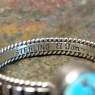 Silver ring with signature on the inner band, no stones or decoration present.
