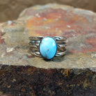 Golden Hills turquoise stone with subtle matrix veining sits in a smooth silver bezel, framed by ribbed bands.