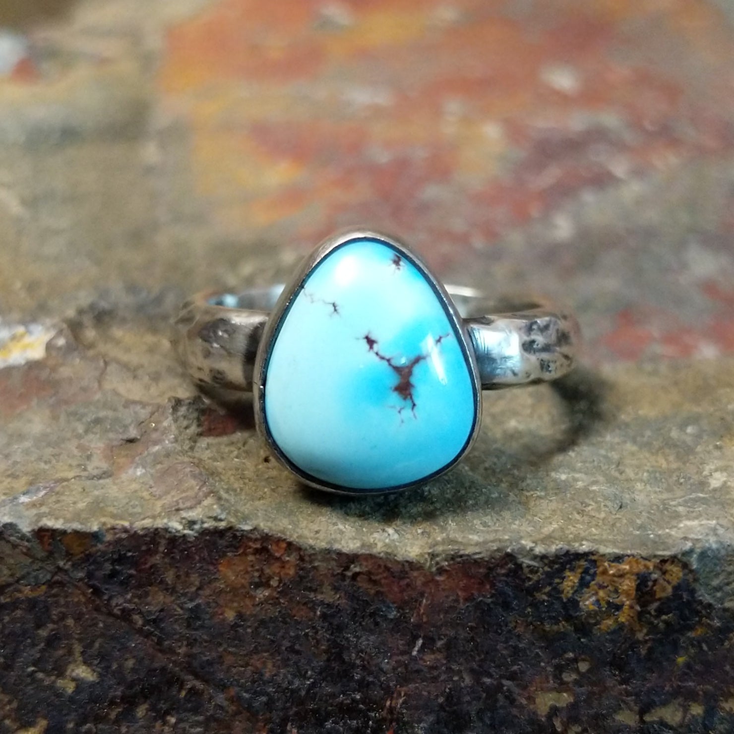 Triangular turquoise bezel with brown matrixes.