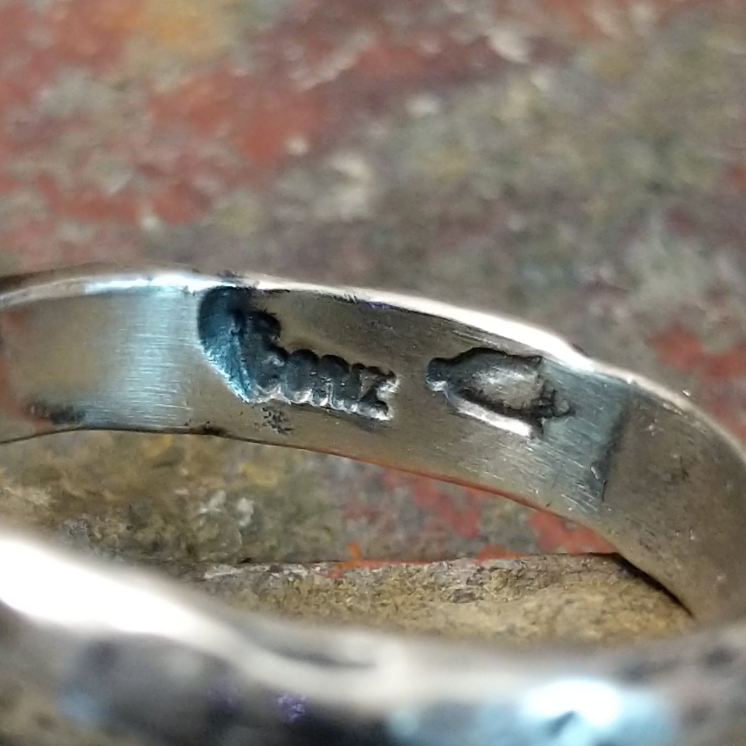 Signature found inside textured band.