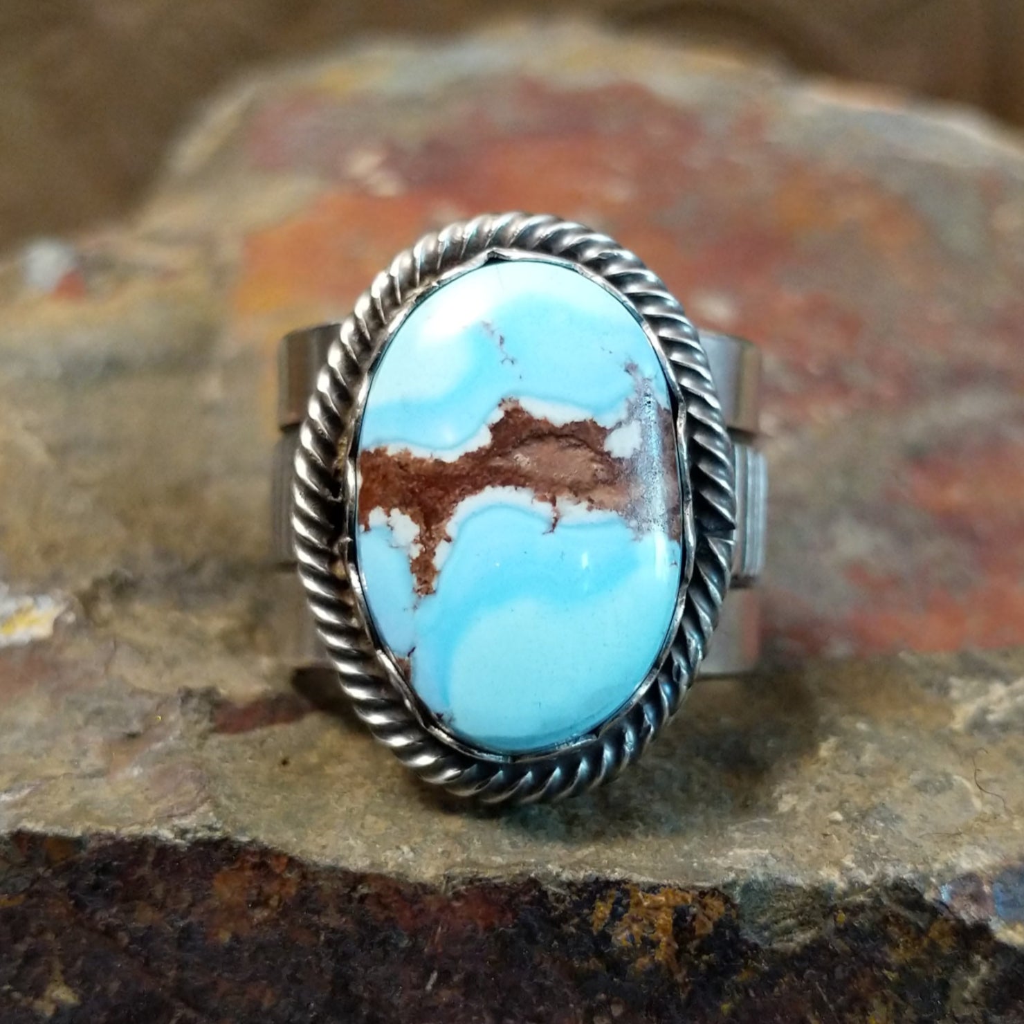 Golden Hills turquoise stone with striking matrix veining sits in a twisted rope silver bezel.