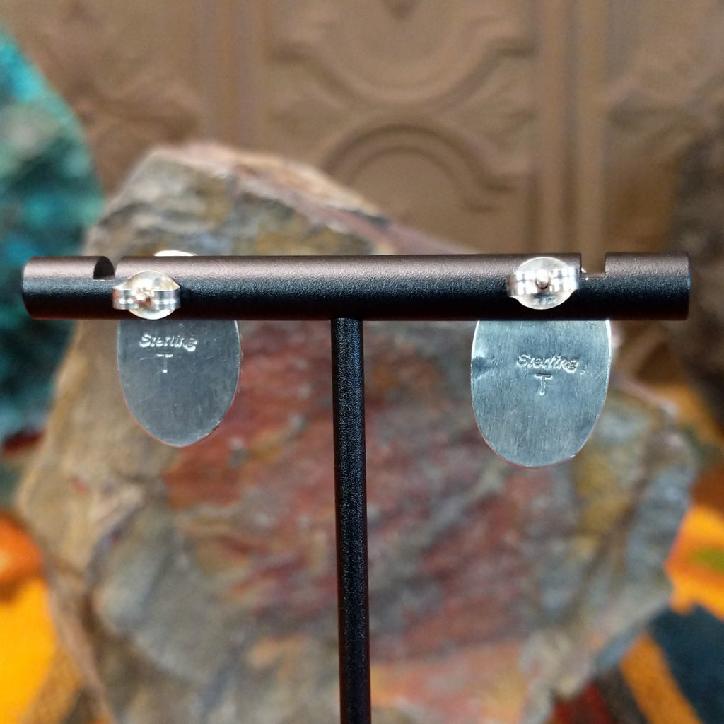 The backings feature the artist's signature on the back.