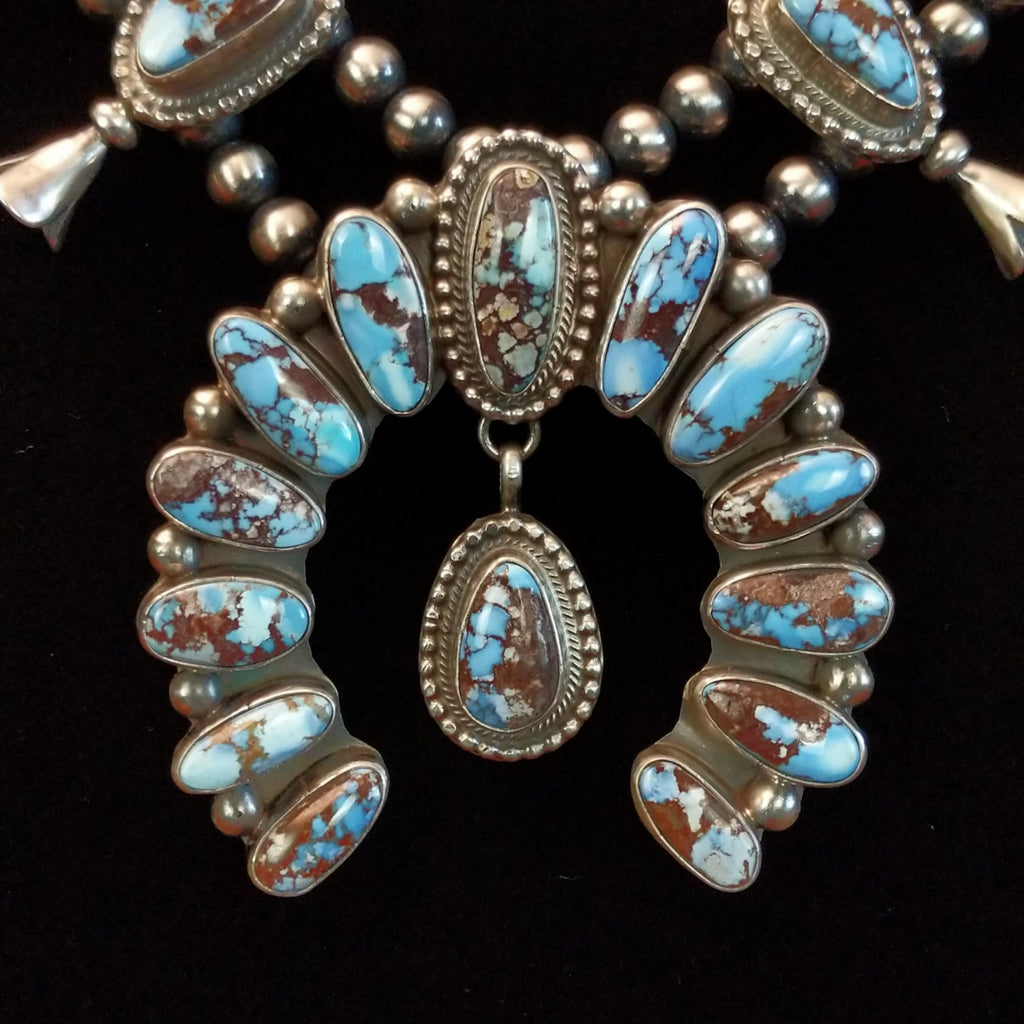 Close up of golden hills turquoise necklace with naja pendant.