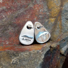 The rear of the golden hills turquoise triangular earrings by Diane Wylie reveals the silver post and backing behind the turquoise stone. The simple bezel’s underside reflects Southwest Native American craftsmanship.