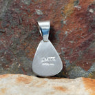 The stamped/signature view features a small hallmark, marking Leon Martinez’s artistry on the sterling silver backing.