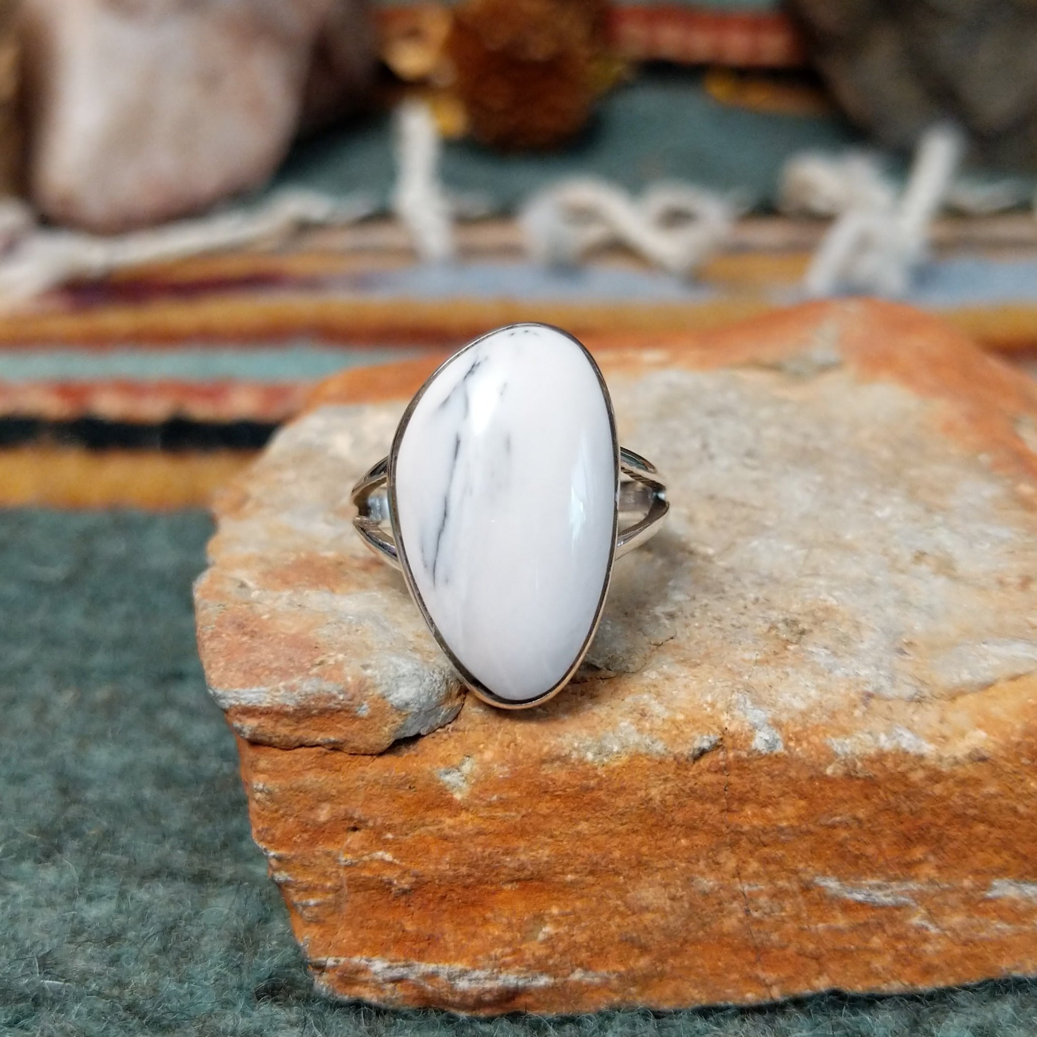 Sterling silver ring by Sheryl Martinez featuring an elongated oval White Buffalo stone with subtle dark veining and an elegant split-shank band.