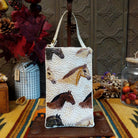 Herd Club Bag by Bamboo Trading featuring embroidered and beaded horse portraits in brown, black, cream, and golden tan on a shimmering white beaded background with a coordinating ivory shoulder strap.