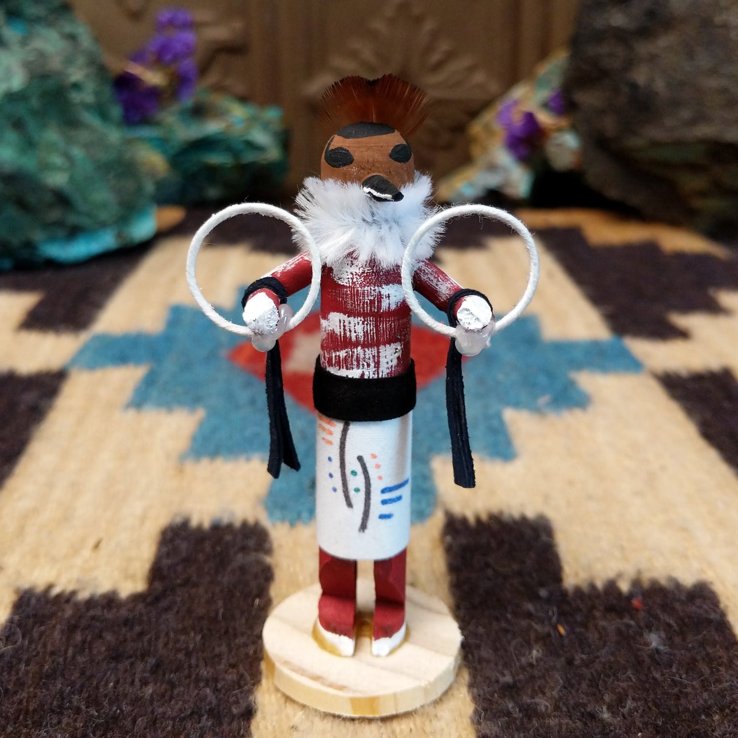 Mini hoop dancer kachina by Rosalind Grey with white hoops, white fur collar, red body, and white geometric-patterned garment.