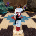 Mini hoop dancer kachina by Rosalind Grey with white hoops, white fur collar, red body, and white geometric-patterned garment.