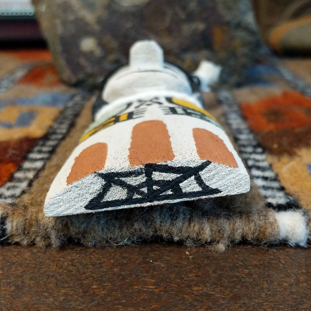 The bottom of the piece is signed.