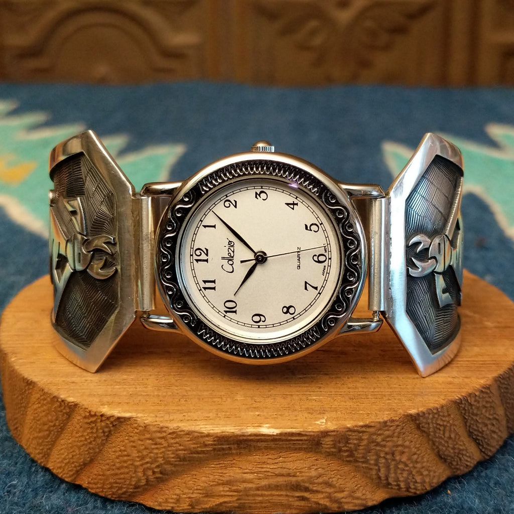 Sterling silver and stainless steel watch with ornate detailing on the bezel and flute players on the bracelet.