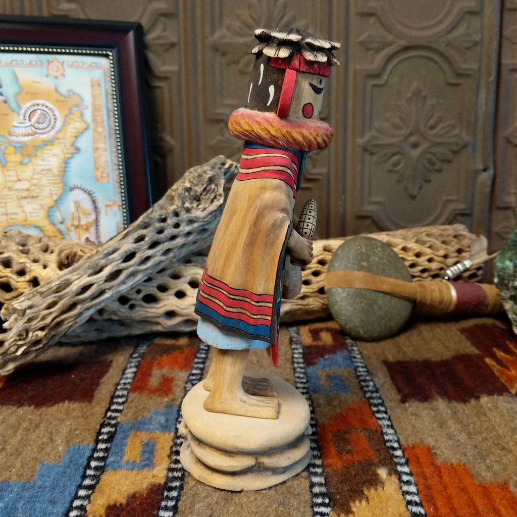 Wood carved into a grandmother kachina with finely carved wood details and colorful painted accents.