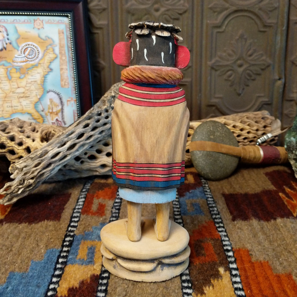 Wood carved into a grandmother kachina with finely carved wood details and colorful painted accents.