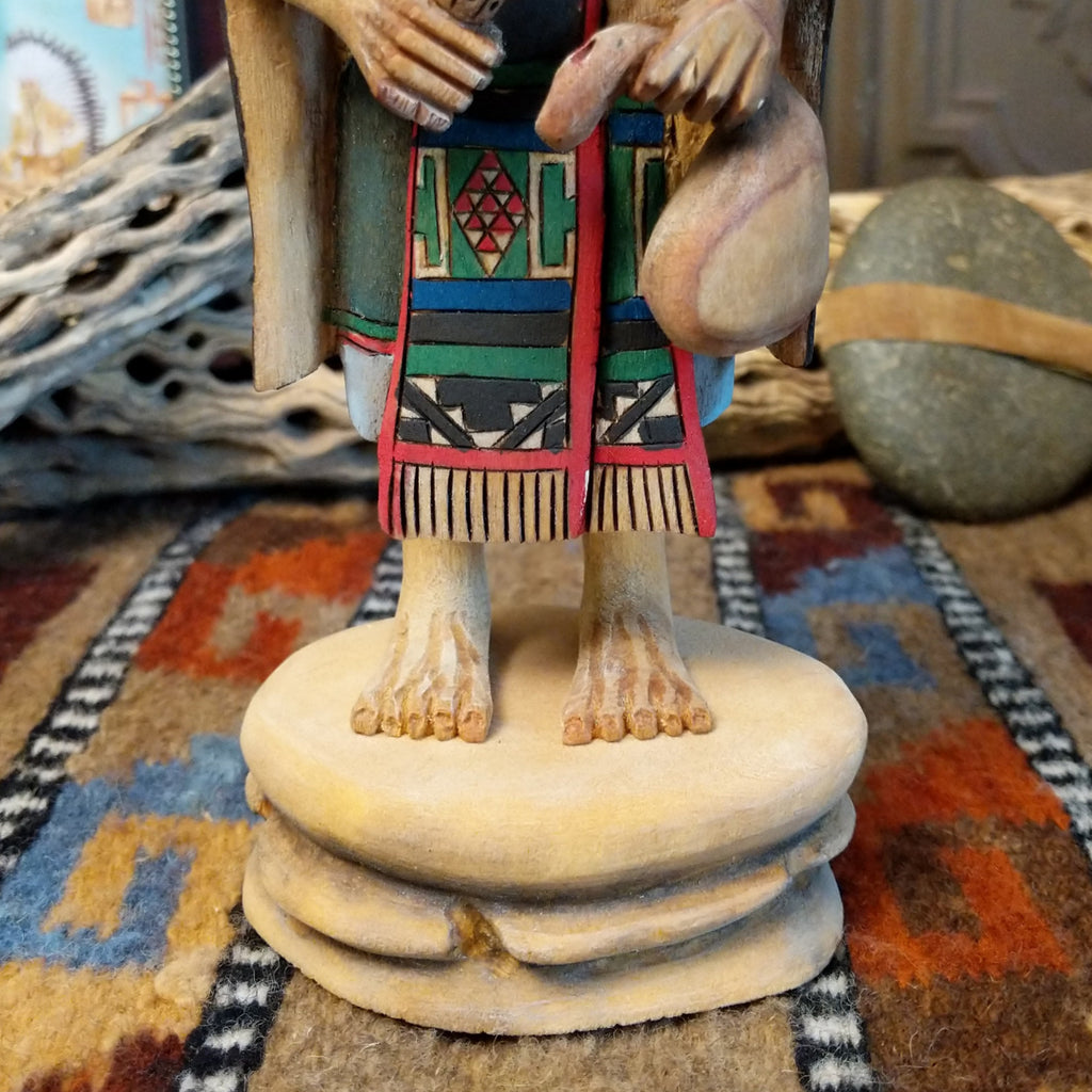 Wood carved into a grandmother kachina with finely carved wood details and colorful painted accents.