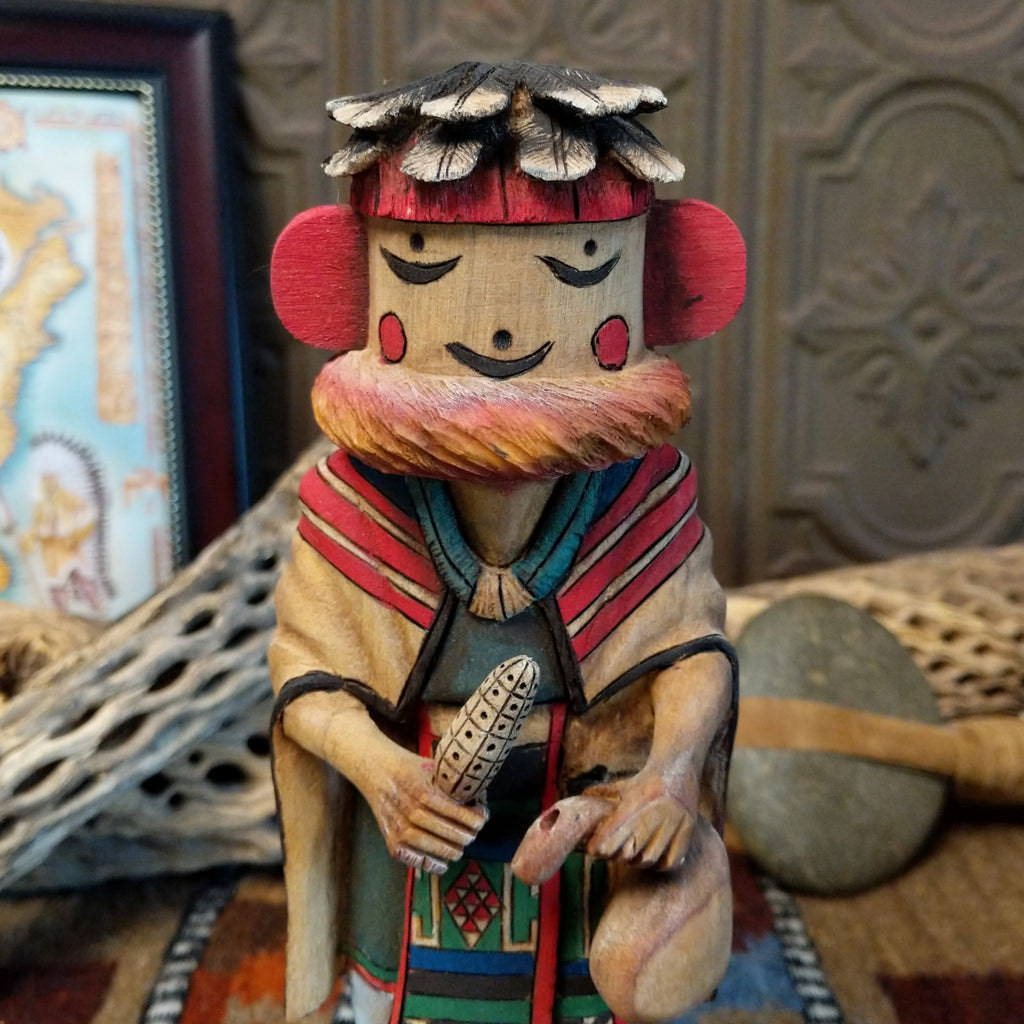 Wood carved into a grandmother kachina with finely carved wood details and colorful painted accents.