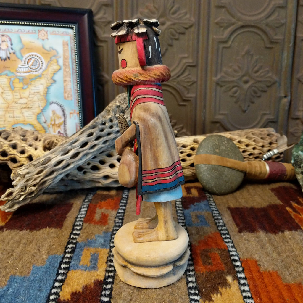 Wood carved into a grandmother kachina with finely carved wood details and colorful painted accents.