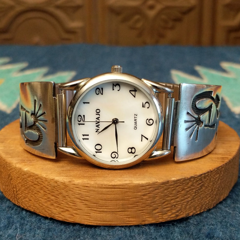 Sterling silver and stainless steel watch with kokopelli motifs on the bracelet and semi-adjustable band.