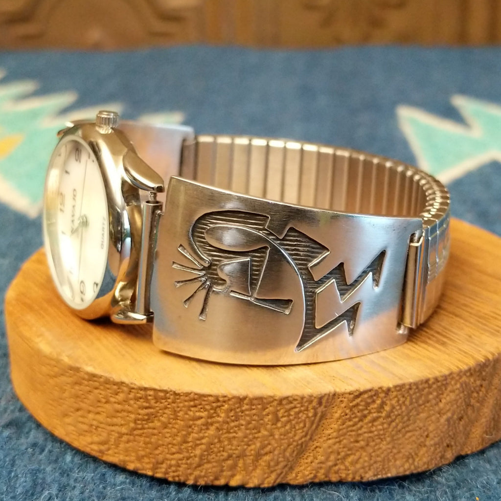 Sterling silver and stainless steel watch with kokopelli motifs on the bracelet and semi-adjustable band.