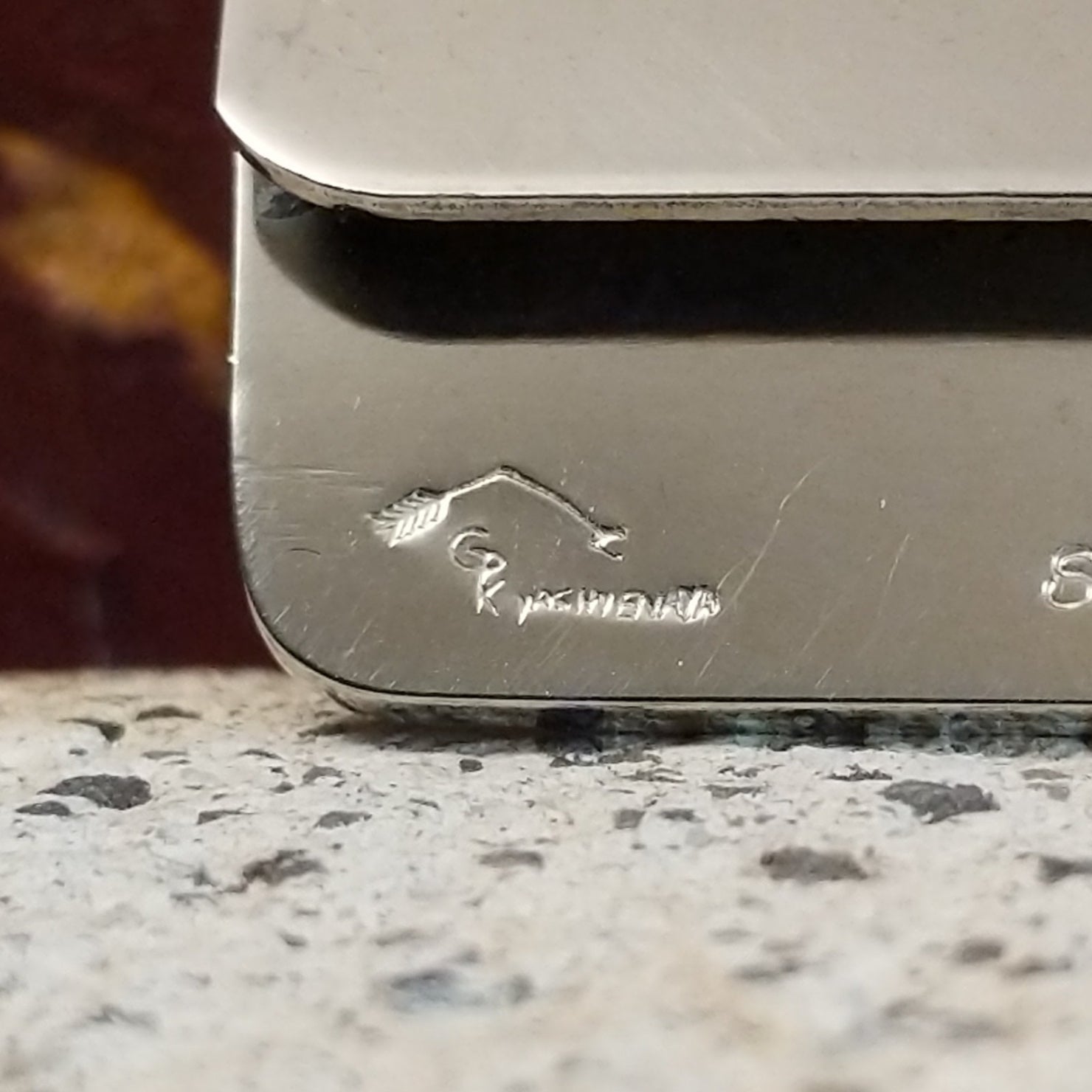 Artists signature on the inside of the sterling silver face.