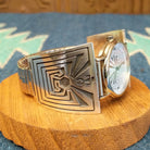 Sterling silver and stainless steel watch with man in the maze motifs on the bracelet and face.