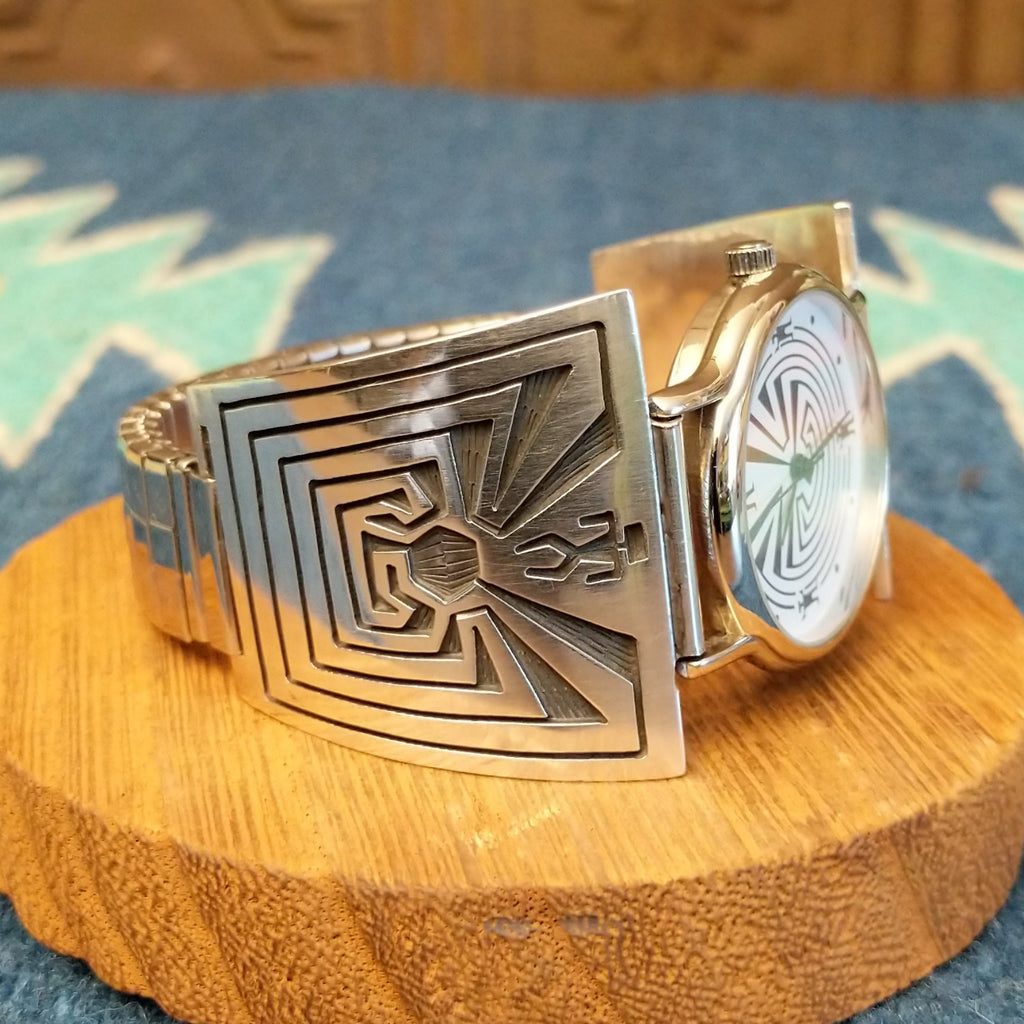 Sterling silver and stainless steel watch with man in the maze motifs on the bracelet and face.