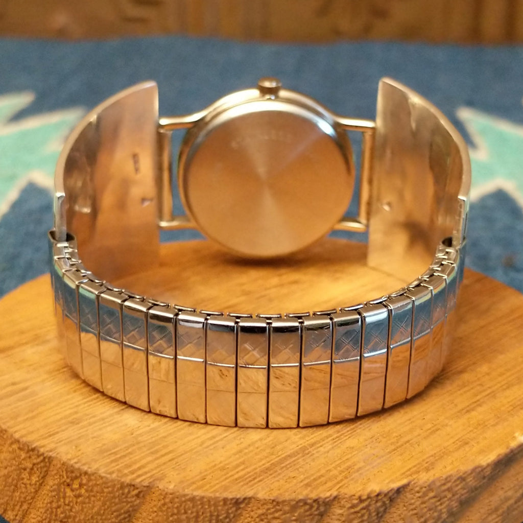 Sterling silver and stainless steel watch with semi-adjustable band.