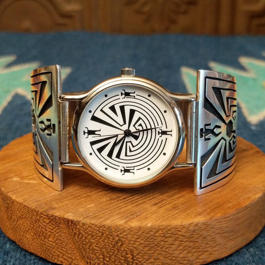 Sterling silver and stainless steel watch with man in the maze motifs on the bracelet and face.