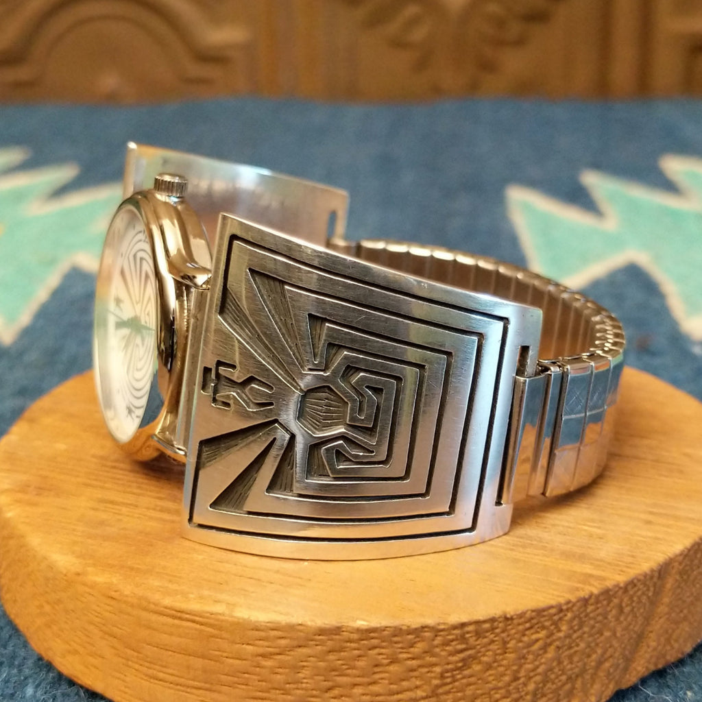 Sterling silver and stainless steel watch with man in the maze motifs on the bracelet and face.
