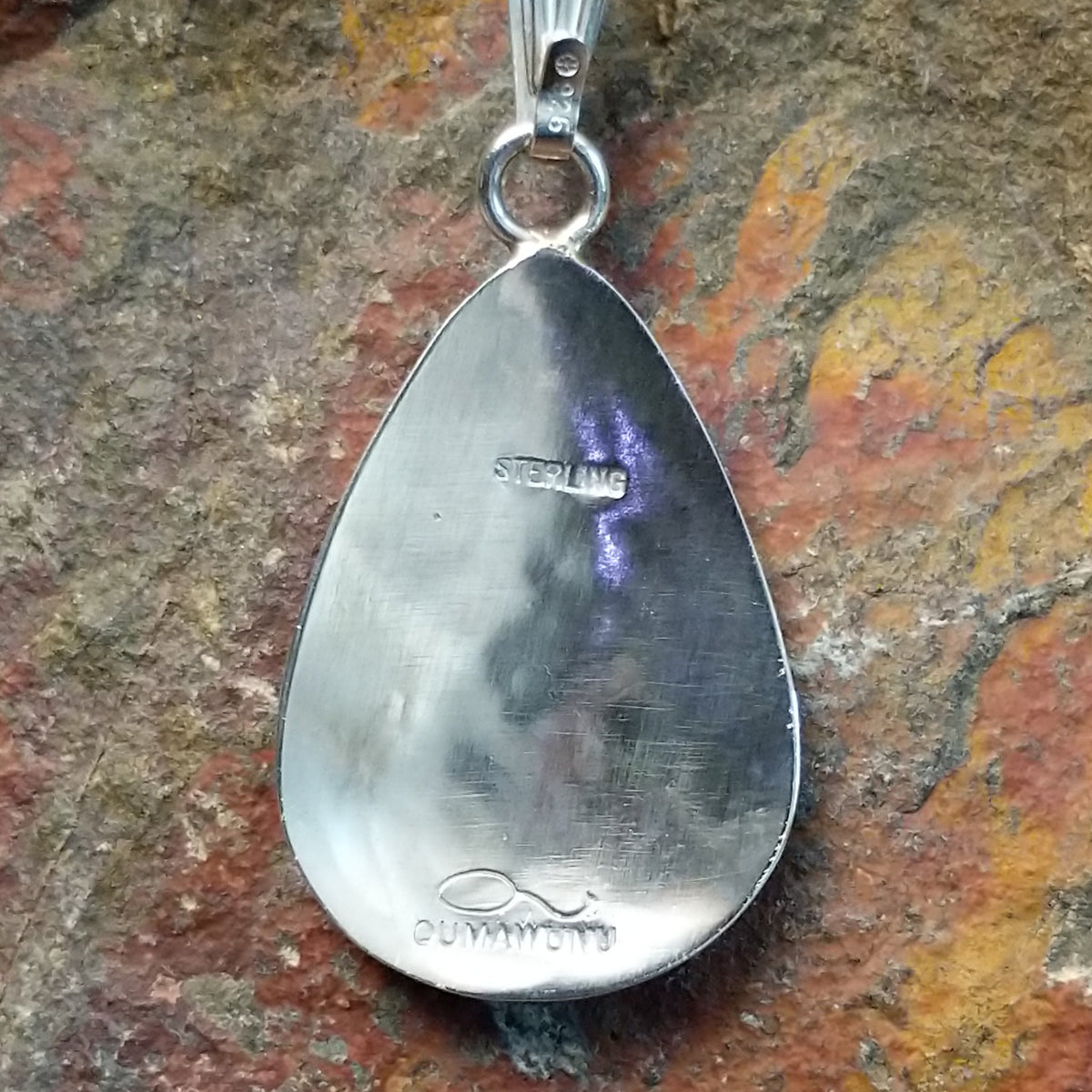 Hopi silver bear paw pendant by Loren Sakeva featuring a teardrop shape with polished silver and darkened recessed overlay-style detailing; artisan and Sterling Silver stamp.