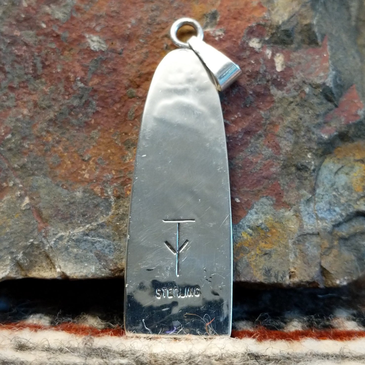 The back showcases the authentication stamp.