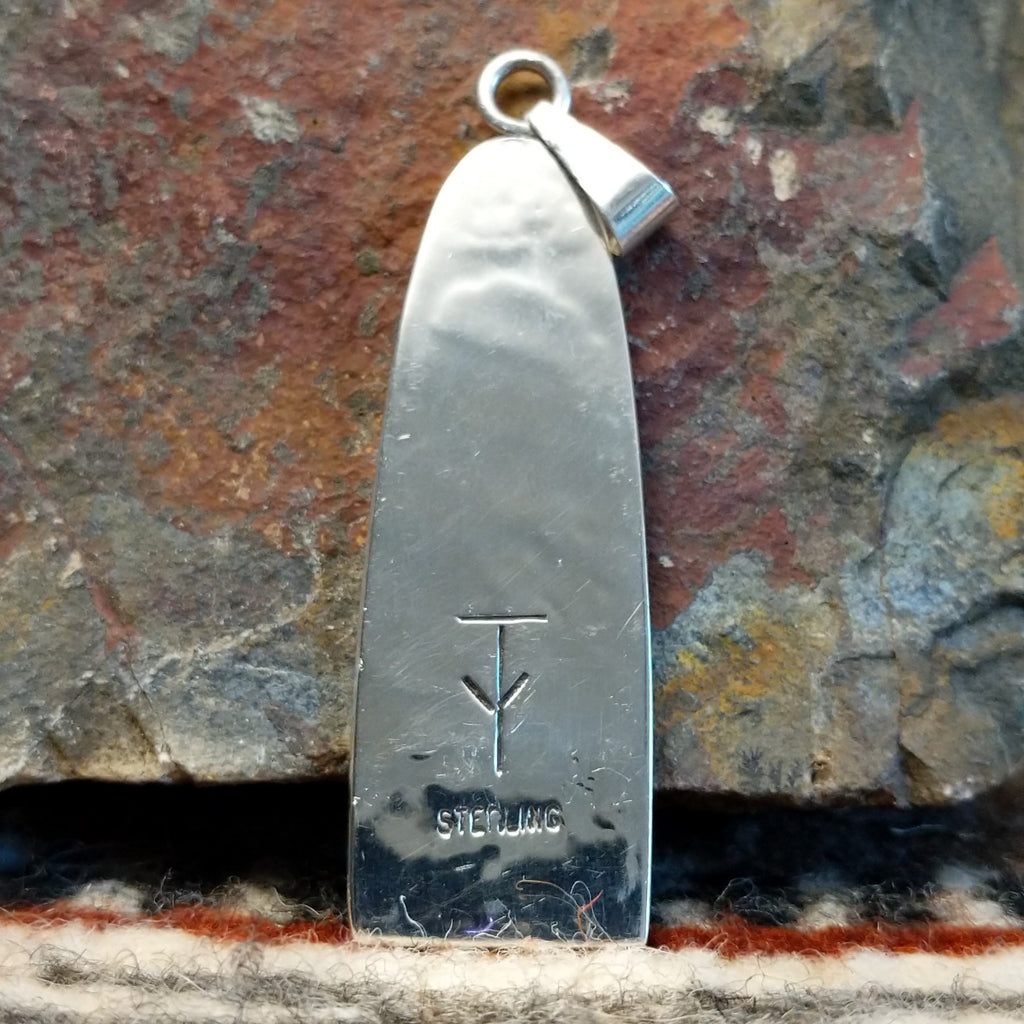 The back showcases the authentication stamp.