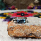 Hopi Silver Ring with a wide sterling silver band featuring a geometric overlay design, polished silver surfaces, and dark oxidized recessed details.