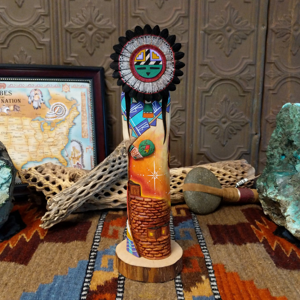 Wood carved into a sun kachina painted with vibrant colors and intricately carved wood details.