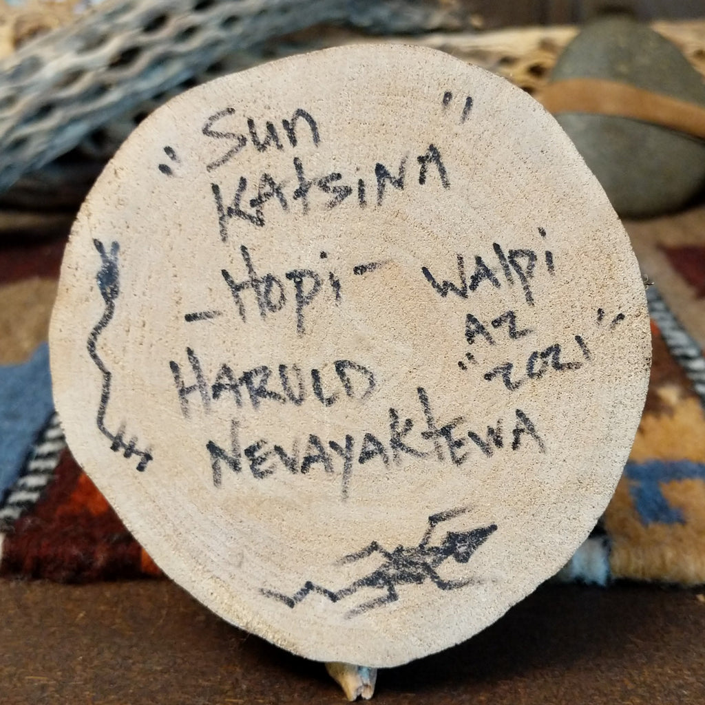 The underside of the base showcases the artisan's signature and information about the piece.