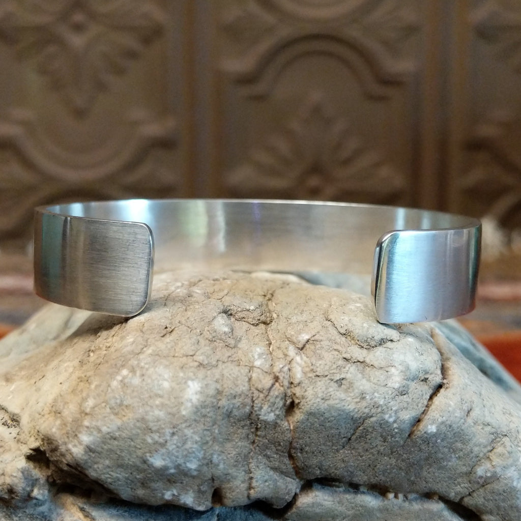 The back is brushed sterling silver.