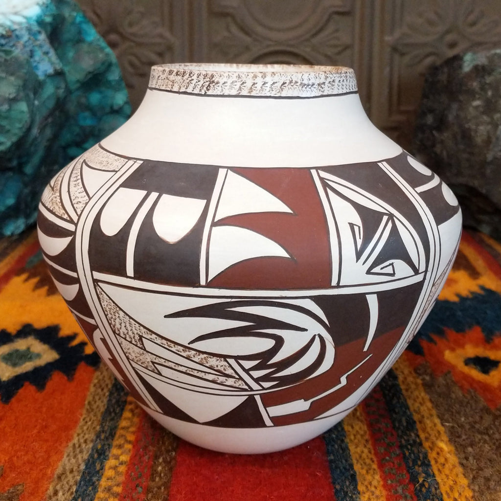 White clay pot with various geometric designs and sponge detailing.
