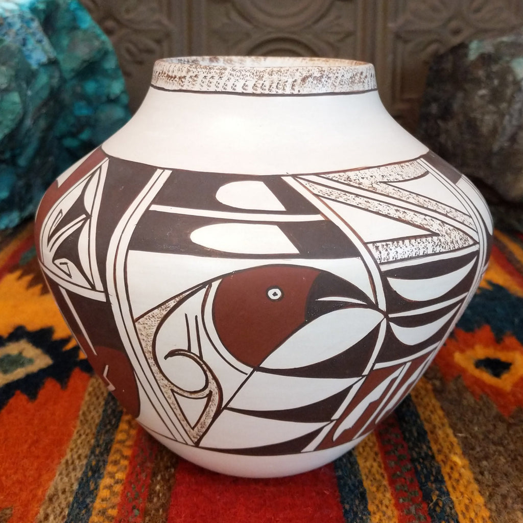 White clay pot with various geometric designs and sponge detailing.