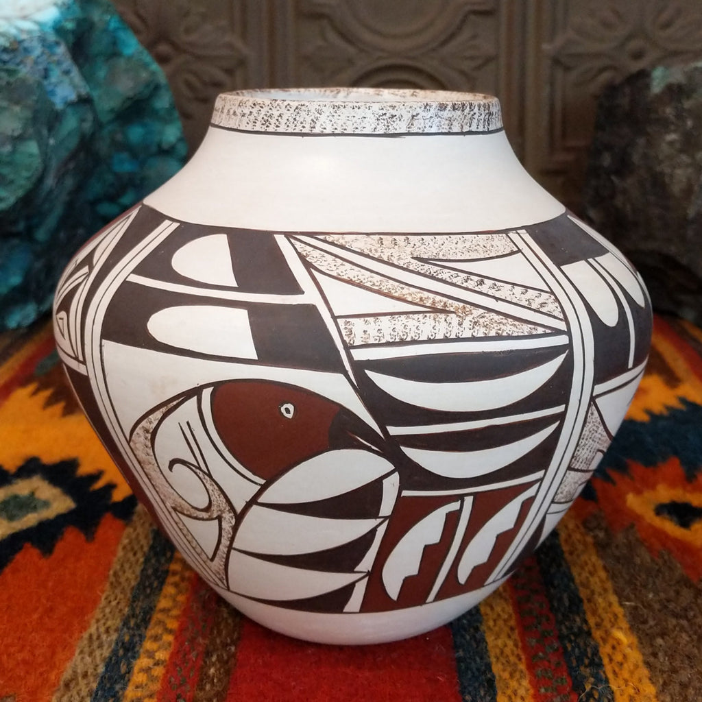 White clay pot with various geometric designs and sponge detailing.