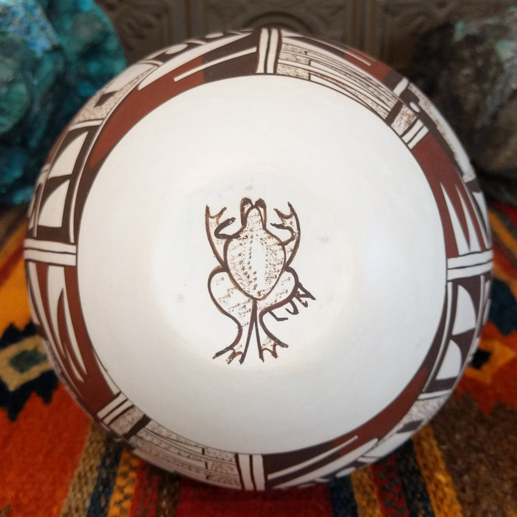The base shows the artisan's unique signature of a frog.