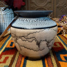 This distinctive Horsehair Pottery by Roger Calhoun features a rounded ceramic vessel with natural earth tones, delicate black horsehair patterns, a decorative crackled upper section, and a wide black rim.